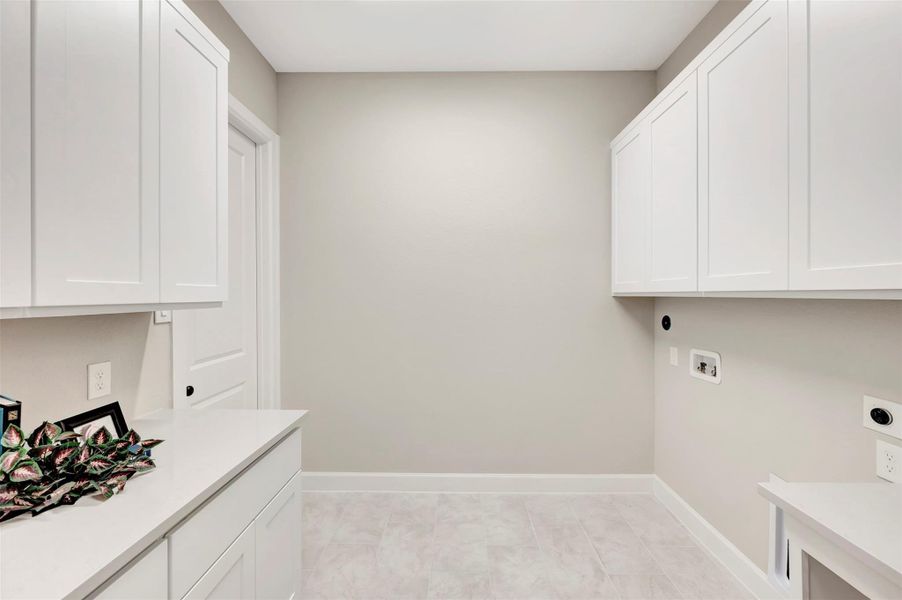 Utility room is plumbed for gas and electric dryer, plus lots of extra cabinets!