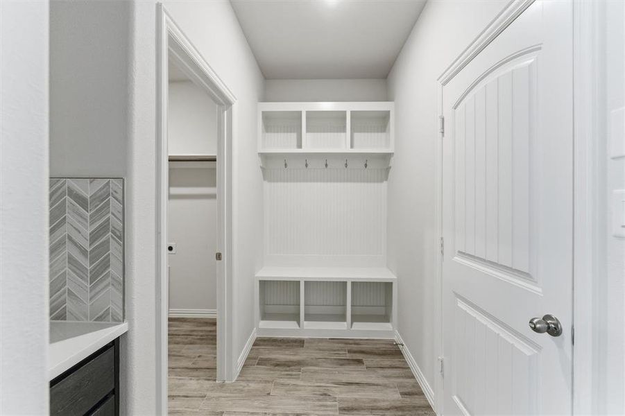Mudroom featuring light wood-style floors and baseboards Mudroom featuring light wood-style floors and baseboards