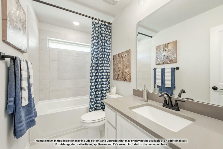 Bathroom with white tub, tiled shower surround, single vanity with gray countertop, and large mirror