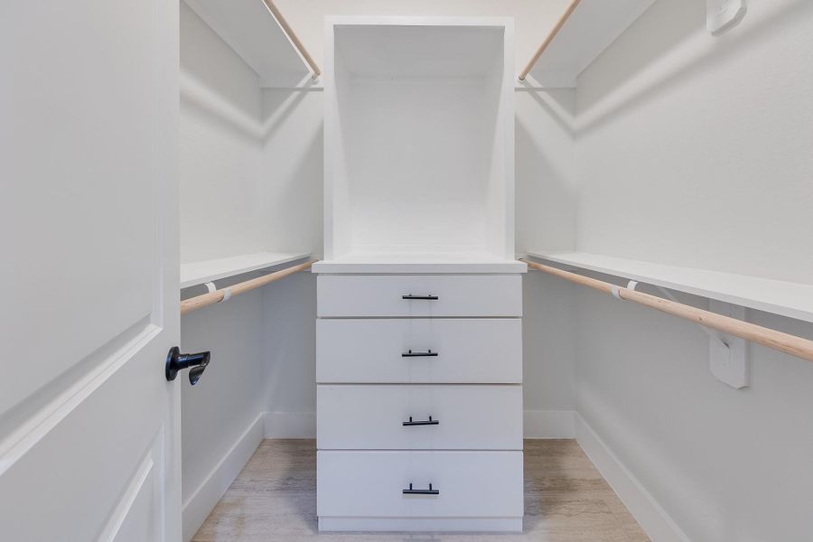 Primary suite with separate walk-in closets for her and him, offering plenty of space and organization for both. Primary suite with separate walk-in closets for her and him, offering plenty of space and organization for both.