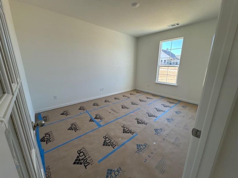 Empty room featuring baseboards