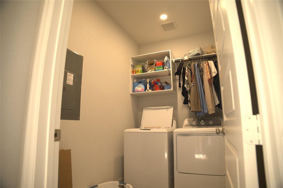 Washroom with independent washer and dryer, electric panel, and recessed lighting Washroom with independent washer and dryer, electric panel, and recessed lighting