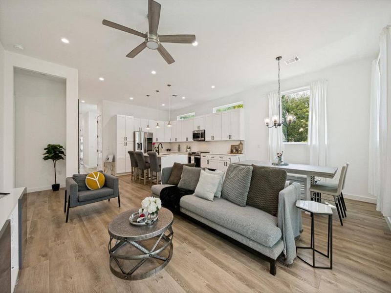 An open-concept living space with sleek flooring and ample natural light creates an inviting atmosphere. An open-concept living space with sleek flooring and ample natural light creates an inviting atmosphere.