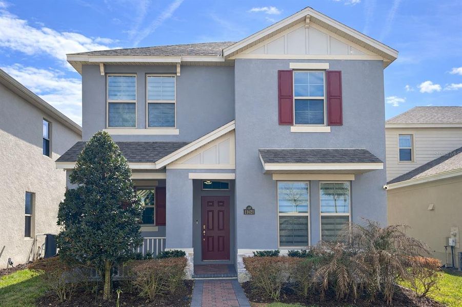 Front exterior of a new home in Waterleigh, Winter Garden, FL, highlighting curb appeal (Image 20).
