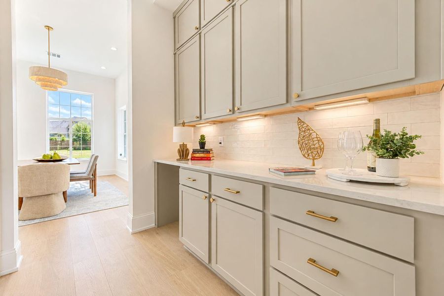 Thoughtfully designed butler’s pantry connects the dining room to the kitchen, offering additional cabinetry, generous counter space, and stylish display shelving. An ideal setup for serving, entertaining, and keeping prep conveniently tucked away from the main gathering spaces. Thoughtfully designed butler’s pantry connects the dining room to the kitchen, offering additional cabinetry, generous counter space, and stylish display shelving. An ideal setup for serving, entertaining, and keeping prep conveniently tucked away from the main gathering spaces.