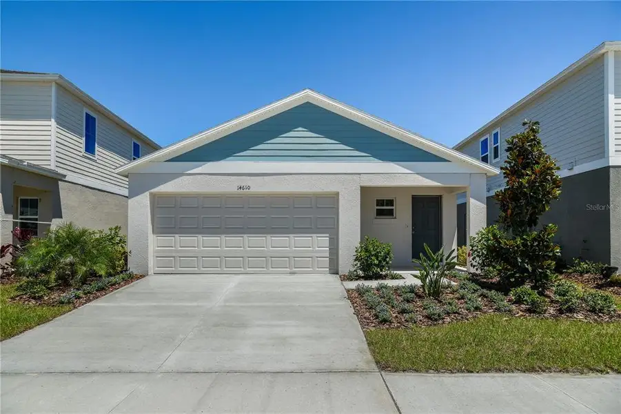 Front exterior of a new home in Scenic Terrace, Haines City, FL, highlighting curb appeal (Image 1). Front exterior of a new home in Scenic Terrace, Haines City, FL, highlighting curb appeal (Image 1).