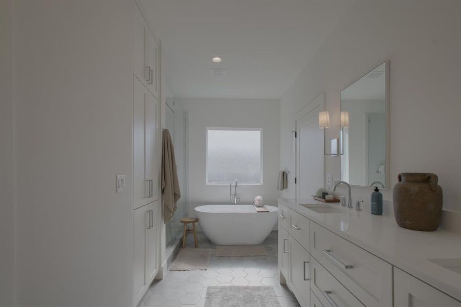 Bathroom with a tub to relax in, tile patterned flooring, and vanity