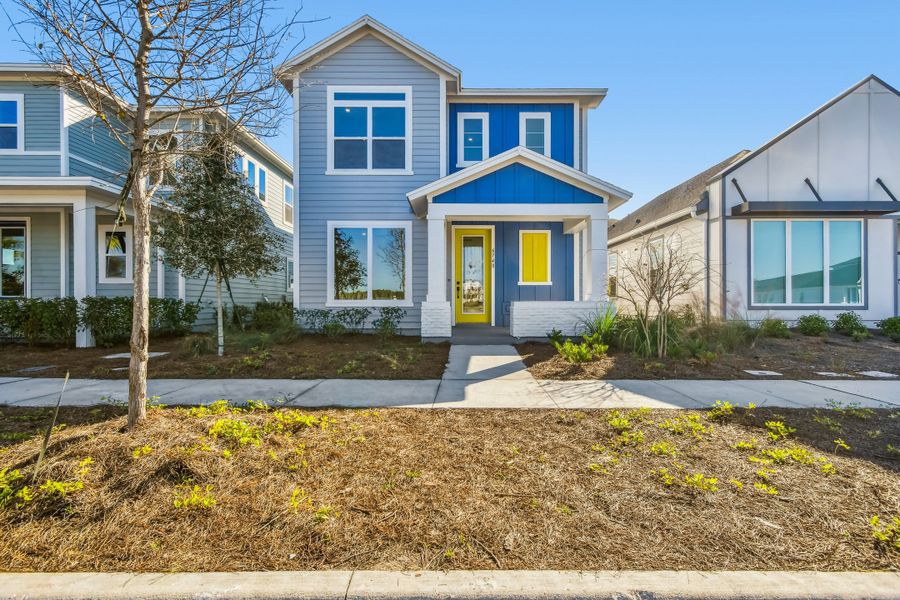 Front exterior of a new home in Weslyn Park in Sunbridge 34', St. Cloud, FL, highlighting curb appeal (Image 2).