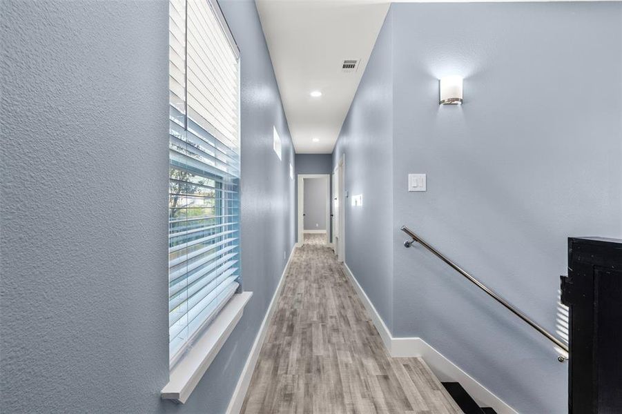 Hall with light hardwood / wood-style floors