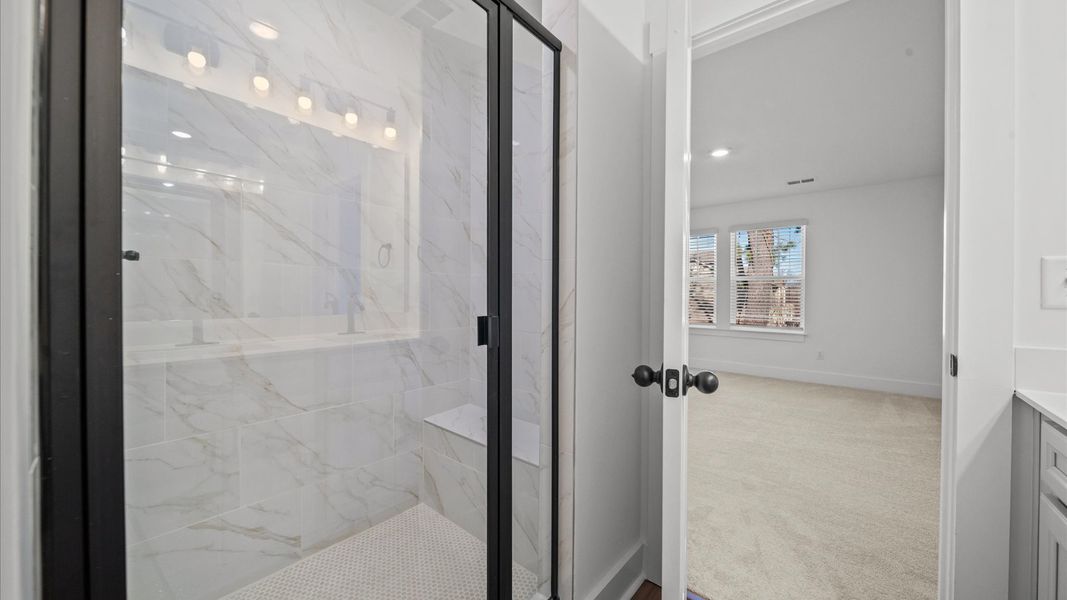 Highly functional and elegant en-suite with a large tiled walk-in shower and refined finishes in Arden, NC