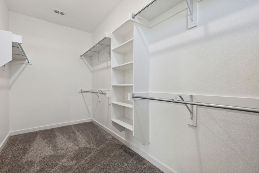 Primary Closet in the Heisman home plan by Trophy Signature Homes – REPRESENTATIVE PHOTO