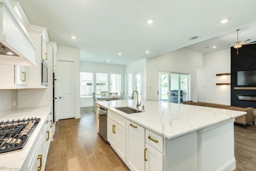 This view captures the open-concept kitchen, dining area, and family room, creating a seamless flow that is ideal for both entertaining and family gatherings.