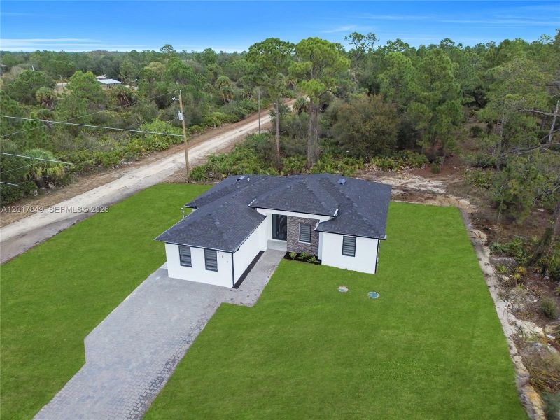 Front exterior of a new home in , Lehigh Acres, FL, highlighting curb appeal (Image 24).