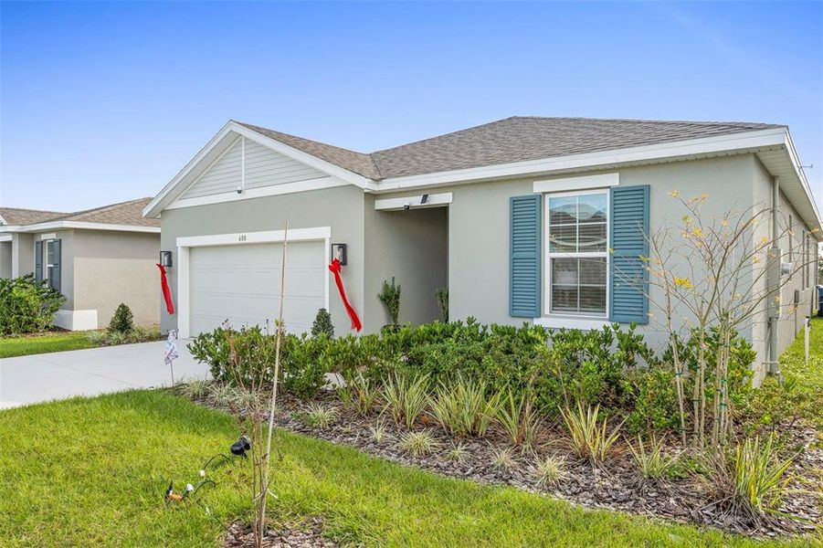 Front exterior of a new home in , Lake Wales, FL, highlighting curb appeal (Image 1). Front exterior of a new home in , Lake Wales, FL, highlighting curb appeal (Image 1).