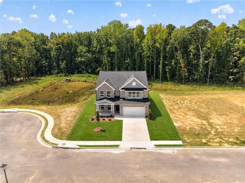 Front exterior of a new home in , Loganville, GA, highlighting curb appeal (Image 1). Front exterior of a new home in , Loganville, GA, highlighting curb appeal (Image 1).