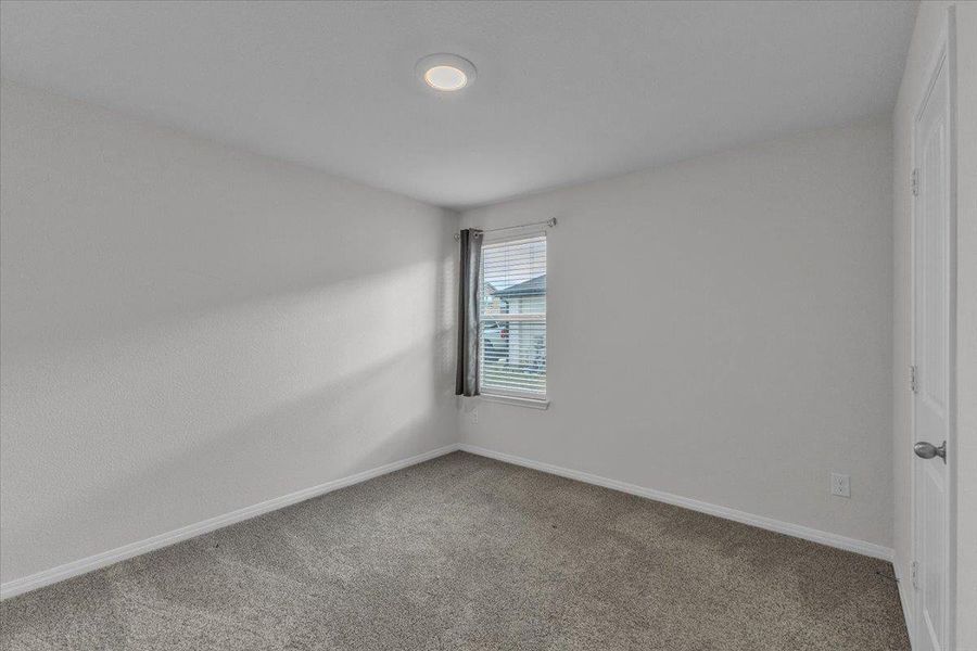 This room features light grey walls and grey carpet flooring