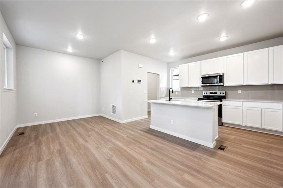 A kitchen with white cabinets. A kitchen with white cabinets.