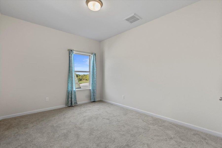 Spare room featuring carpet and baseboards Spare room featuring carpet and baseboards