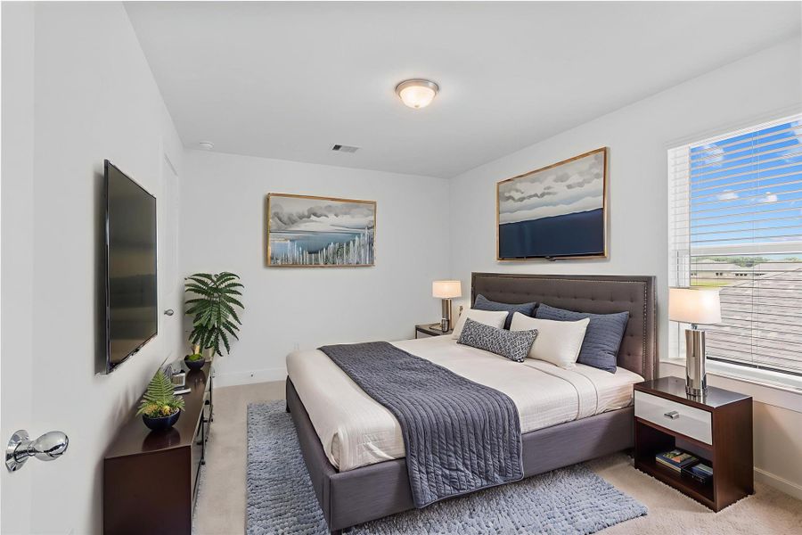 Bright and comfortable secondary bedroom featuring plush carpet, neutral tones, and a large window for beautiful natural light. *Virtually Staged* **Image Representative of Plan Only and May Vary as Built**.