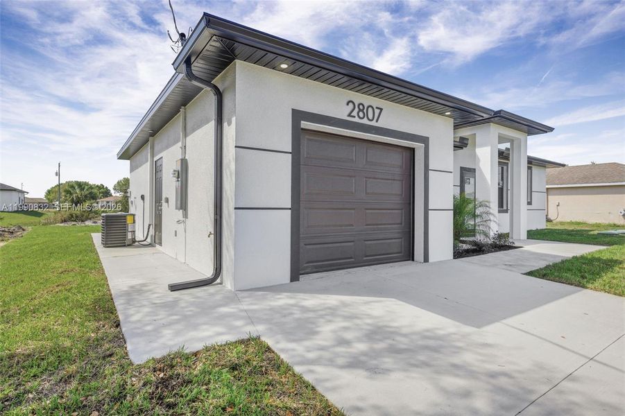 Front exterior of a new home in , Lehigh Acres, FL, highlighting curb appeal (Image 30).