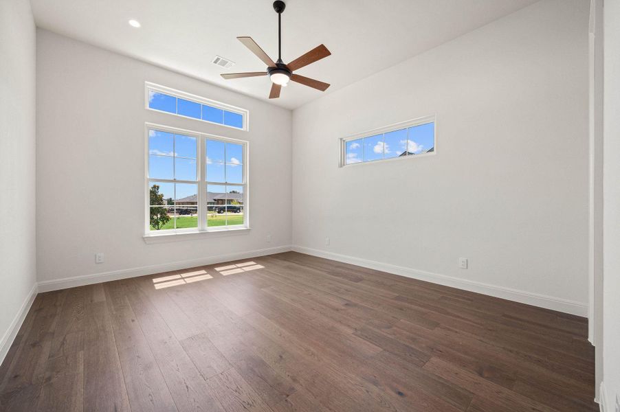 Unfurnished room with wood-style flooring and a ceiling fan