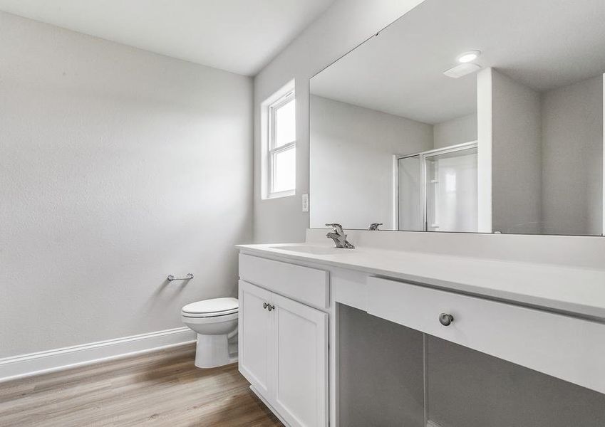 Master bathroom with large vanity and walk-in shower.