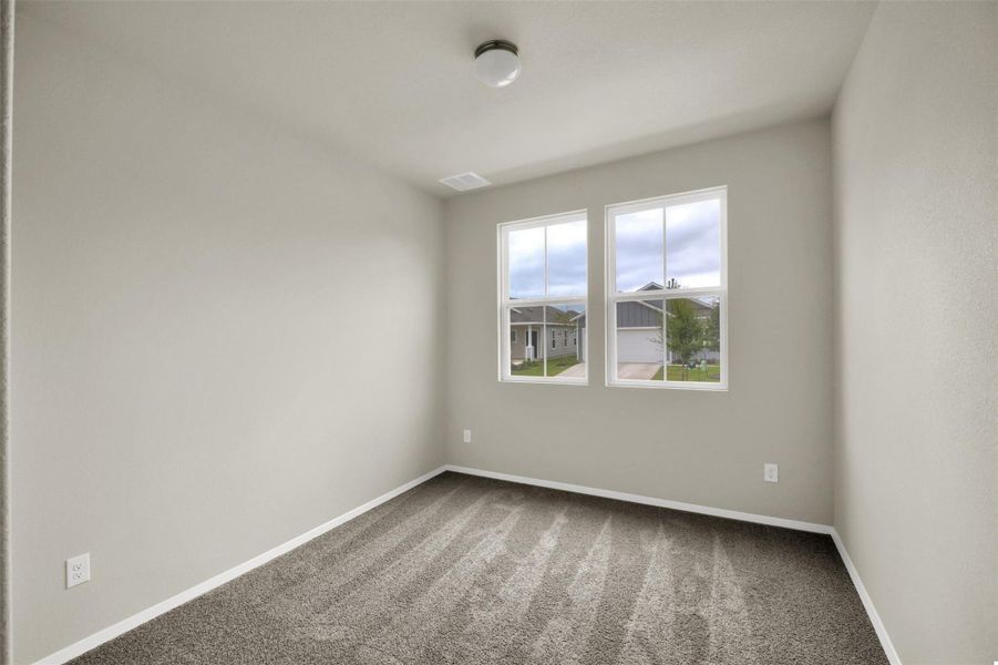 Empty room featuring carpet and baseboards
