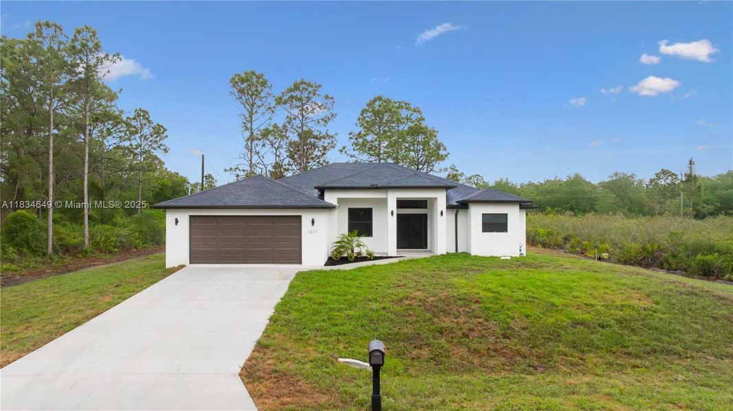 Front exterior of a new home in , Lehigh Acres, FL, highlighting curb appeal (Image 26).