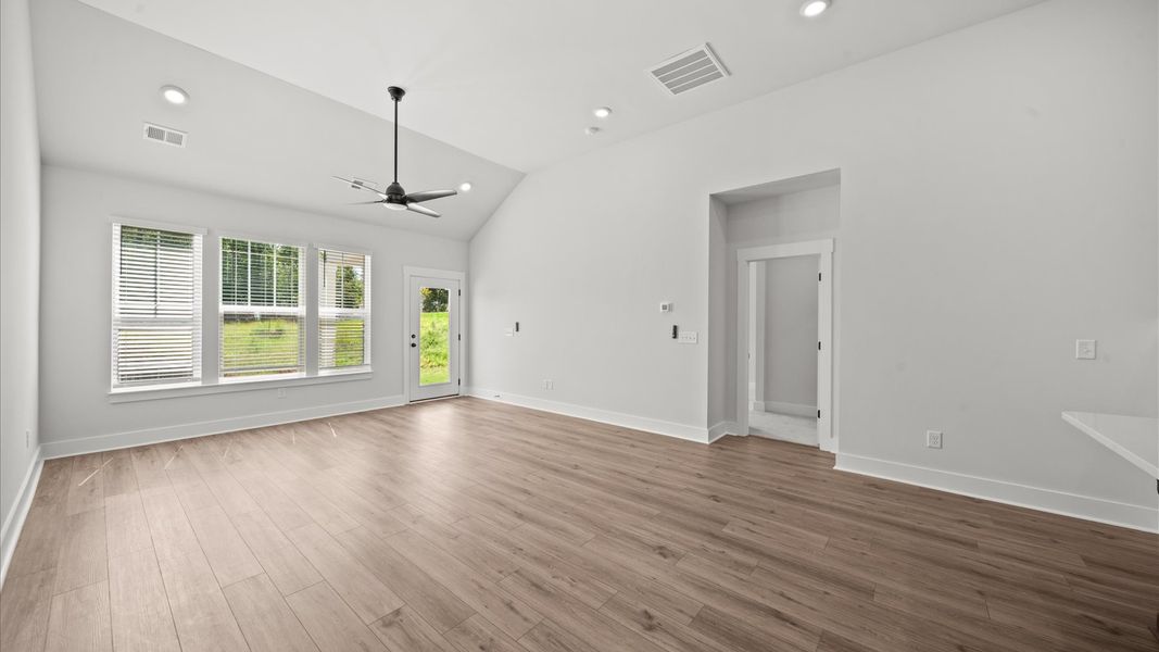 Accomplished design shines in this vibrant family room with dramatic two-story ceilings and open-concept flow