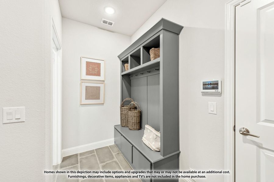 Mudroom with gray built-in storage unit featuring cubbies, coat hooks, bench seat, and upper shelving Mudroom with gray built-in storage unit featuring cubbies, coat hooks, bench seat, and upper shelving