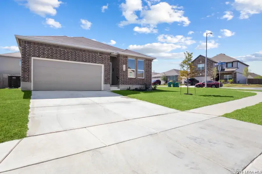 Front exterior of a new home in Hightop Ridge, Converse, TX, highlighting curb appeal (Image 2).