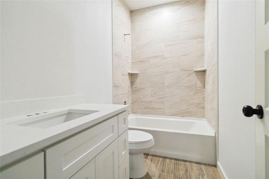 Second full bathroom with tile and shower/tub combo