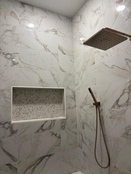 Bathroom with a marble finish shower