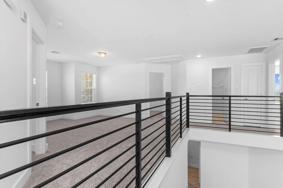 From the dramatic catwalk overlooking the main living area below, access two well-appointed guest bedrooms with generous space and walk-in closets. The open layout and sleek railing design create a light, airy feel with views that impress. From the dramatic catwalk overlooking the main living area below, access two well-appointed guest bedrooms with generous space and walk-in closets. The open layout and sleek railing design create a light, airy feel with views that impress.