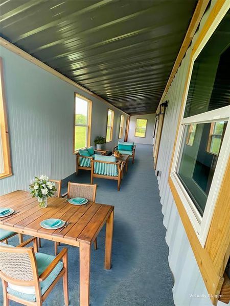 Second floor sunroom featuring carpet floors and healthy amount of natural light with expansive views of the property