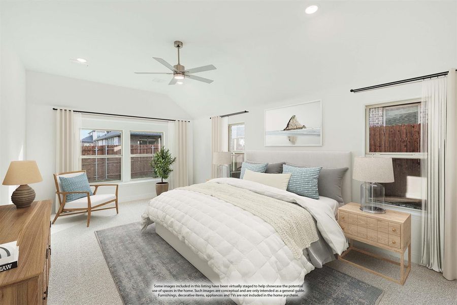 Spacious bedroom with ceiling fan, carpet flooring, large windows, and neutral decor including a queen bed and sitting chair