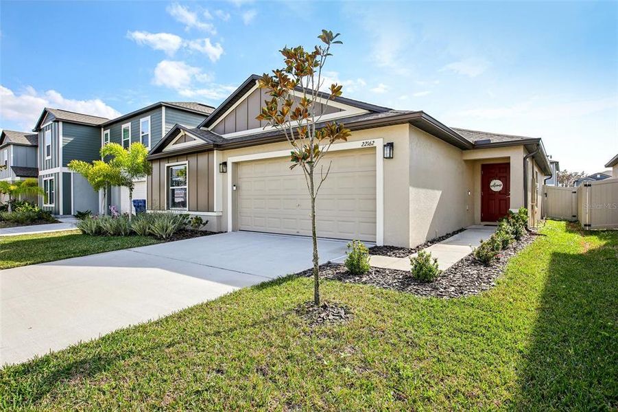Front exterior of a new home in , Land O' Lakes, FL, highlighting curb appeal (Image 2).