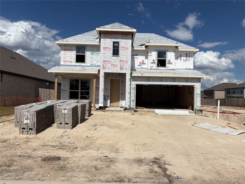 Property in mid-construction featuring a garage and driveway