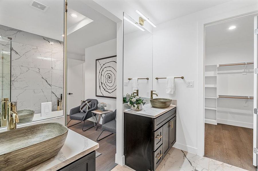 Bathroom with vanity with extensive cabinet space, an enclosed shower, a tray ceiling, and hardwood / wood-style floors