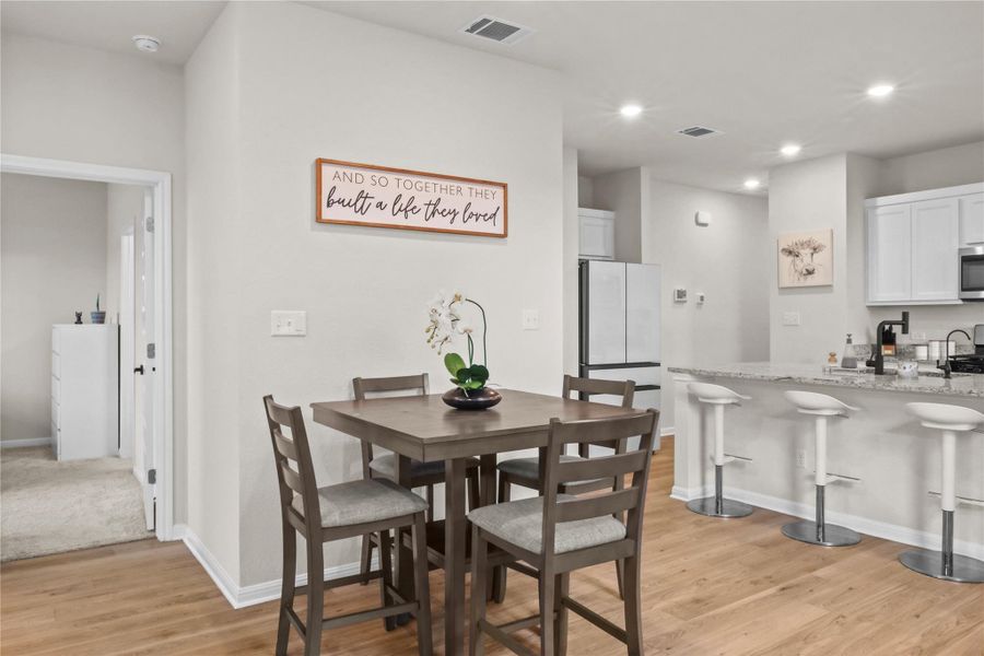 Dining area featuring light wood-style flooring and recessed lighting