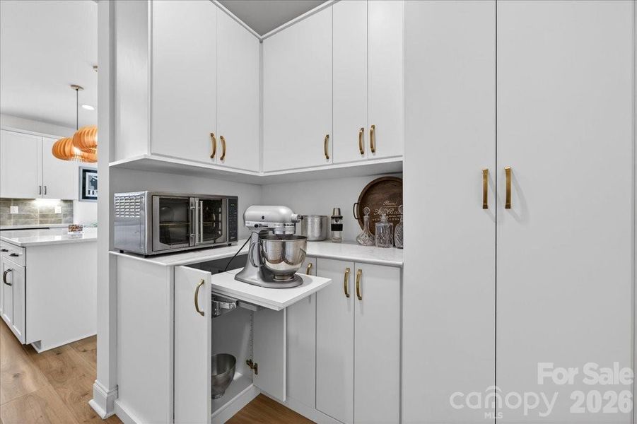 Custom butler's pantry with hidden Kitchen Aid mixer pullout.