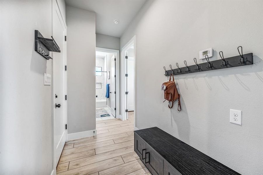 Mudroom featuring wood finish floors and baseboards