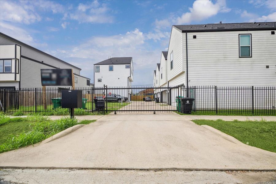 Gated entry opens onto a wide concrete drive shared by a handful of newer homes. Quiet pocket, with a quick turn back out to the main street. Gated entry opens onto a wide concrete drive shared by a handful of newer homes. Quiet pocket, with a quick turn back out to the main street.
