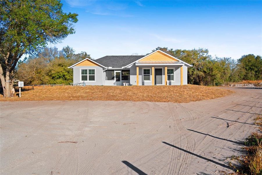 Front exterior of a new home in , Okeechobee, FL, highlighting curb appeal (Image 27).
