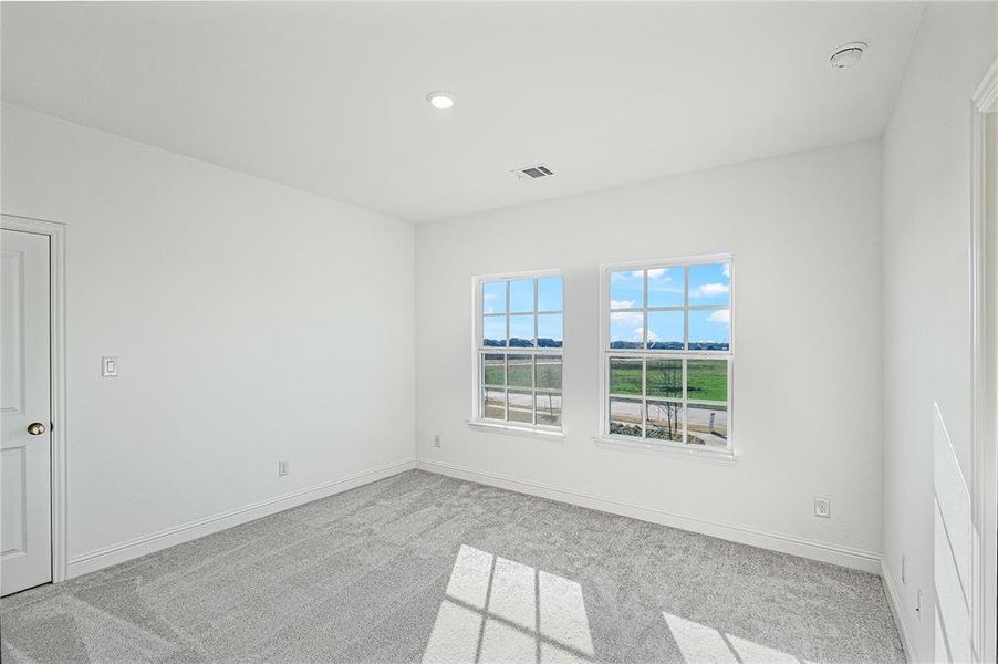 Spare room featuring light colored carpet