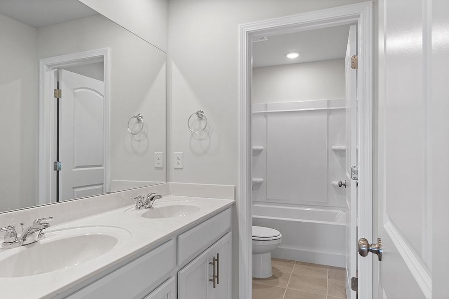 A bathroom with a sink toilet and shower. A bathroom with a sink toilet and shower.