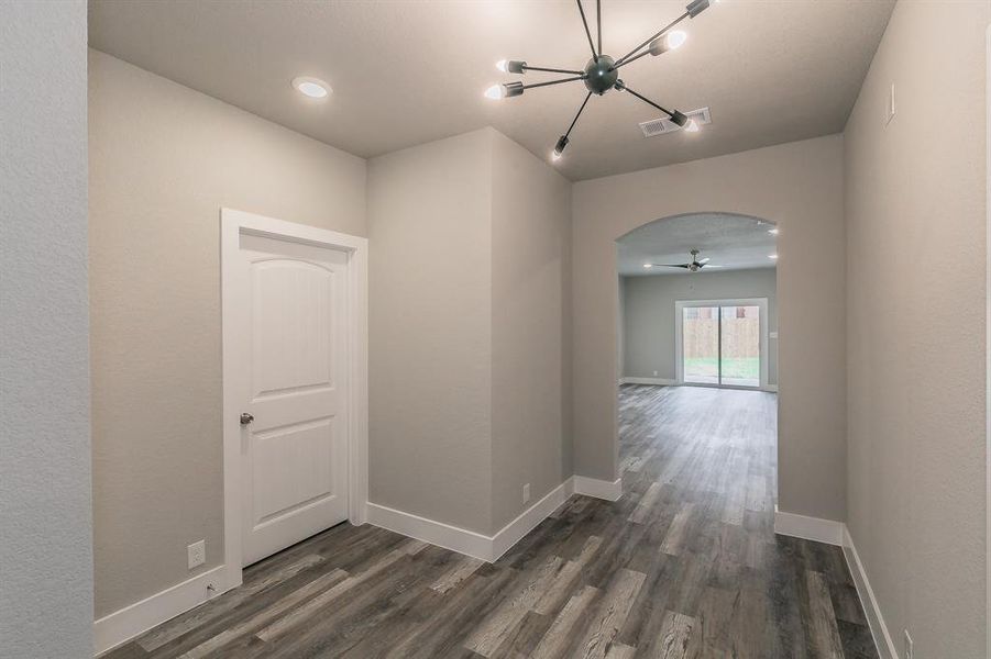 Corridor featuring dark wood-type flooring