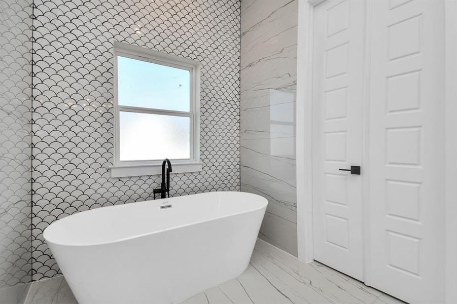 Spa-like bathroom featuring dual vanities, a soaking tub, and a walk-in shower.