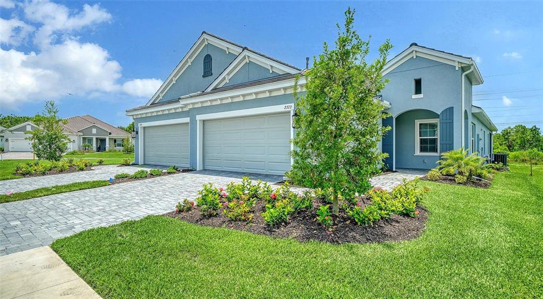 Front exterior of a new home in Windward, Lakewood Ranch, FL, highlighting curb appeal (Image 2).