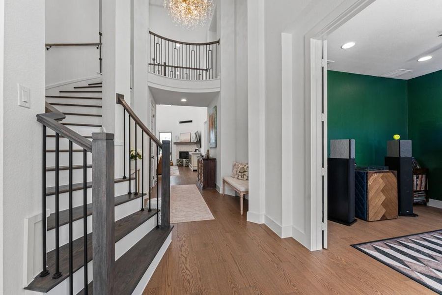 Elegant hardwood flooring extends throughout this graceful entry, complemented by a dramatic curved staircase and a sparkling chandelier. Elegant hardwood flooring extends throughout this graceful entry, complemented by a dramatic curved staircase and a sparkling chandelier.